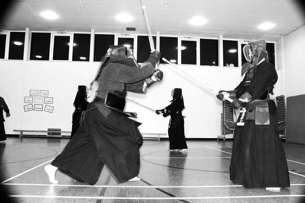 Kendoka practising strikes in pairs